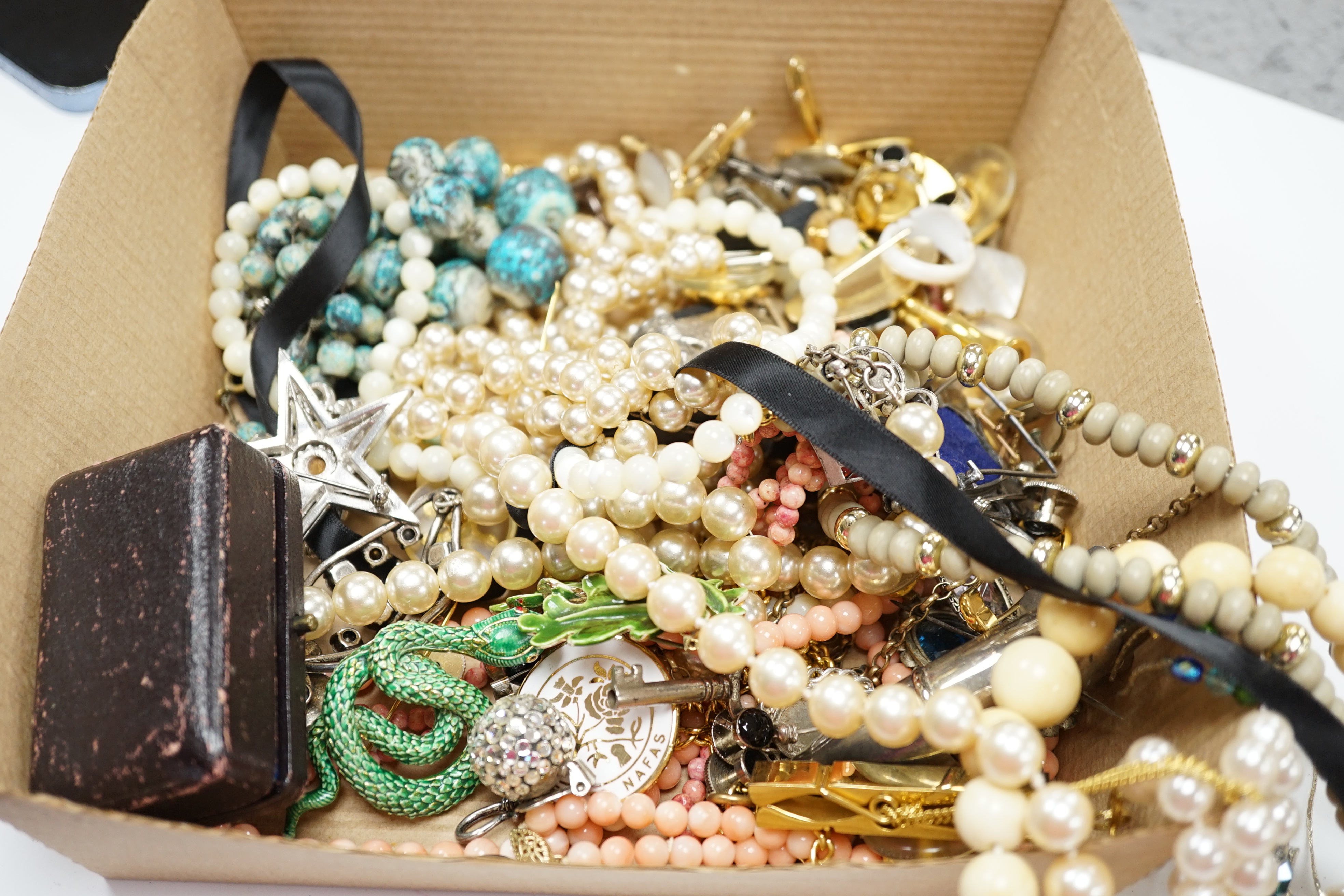 A pair of 9ct and carved coral ear clips, a small 9ct and gem set pendant, a large modern silver mounted white paste set necklace and a group of assorted costume jewellery.
